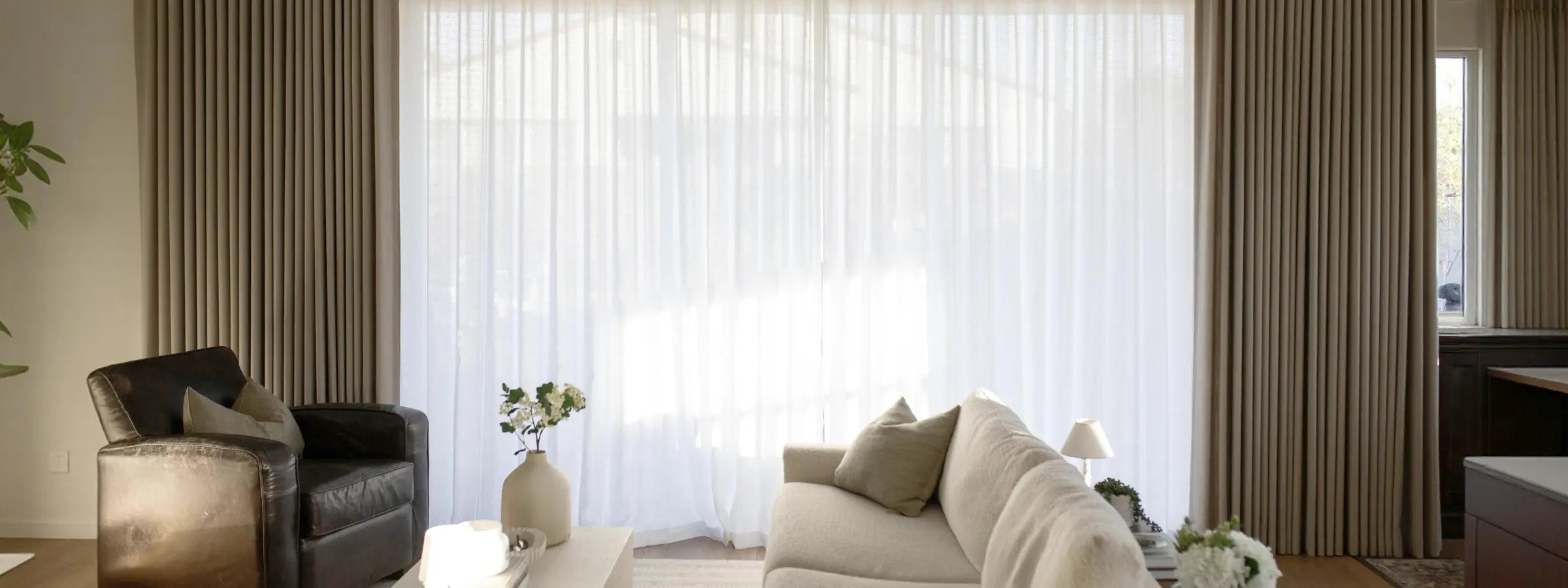 See through sheer curtains softly filtering light, creating a bright and airy ambiance.