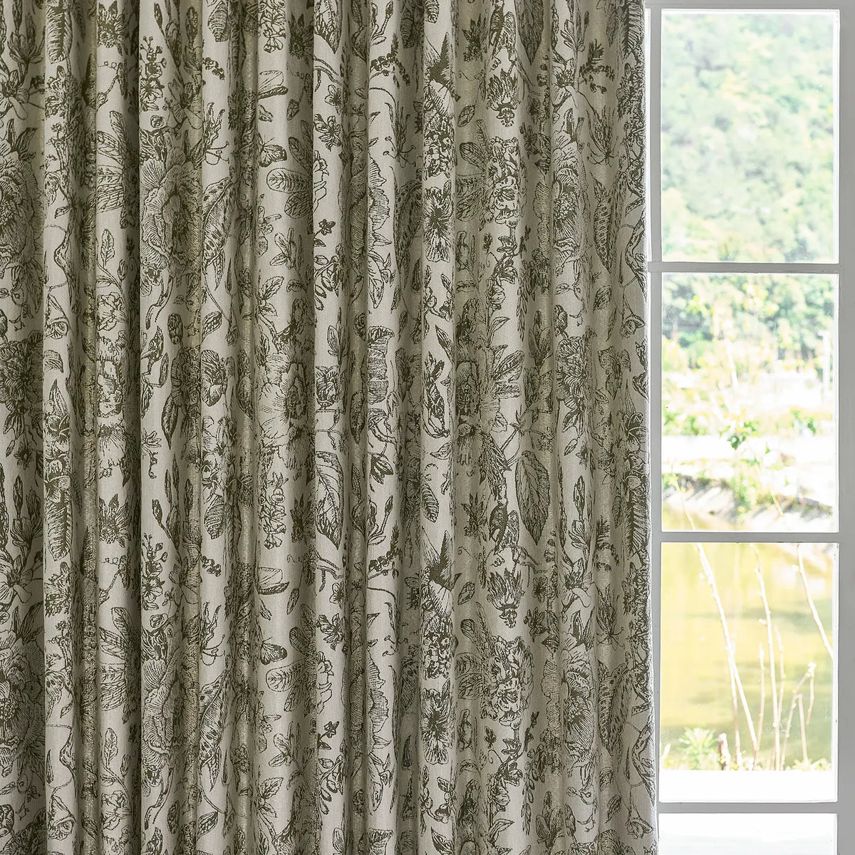 Cymbel H-002_scene_4 green vintage floral jacquard chenille blackout drapes, styled in a bright living room setting showcasing full window coverage and elegant home decor