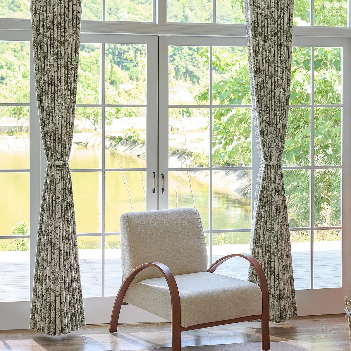 Cymbel H-002_scene_8 green vintage floral jacquard chenille blackout drapes, styled in a bright living room setting showcasing full window coverage and elegant home decor