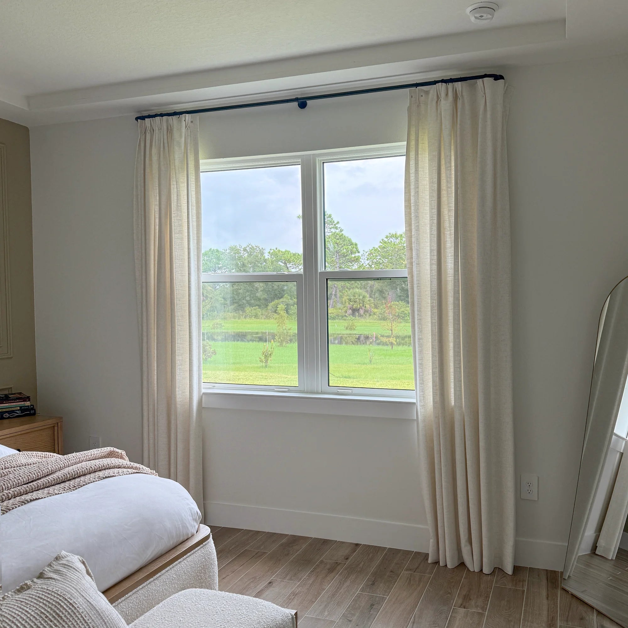 Elara linen curtains 89850-2-2_, elegant drapes in a bedroom showcased to display the product's soft texture and graceful hanging effect