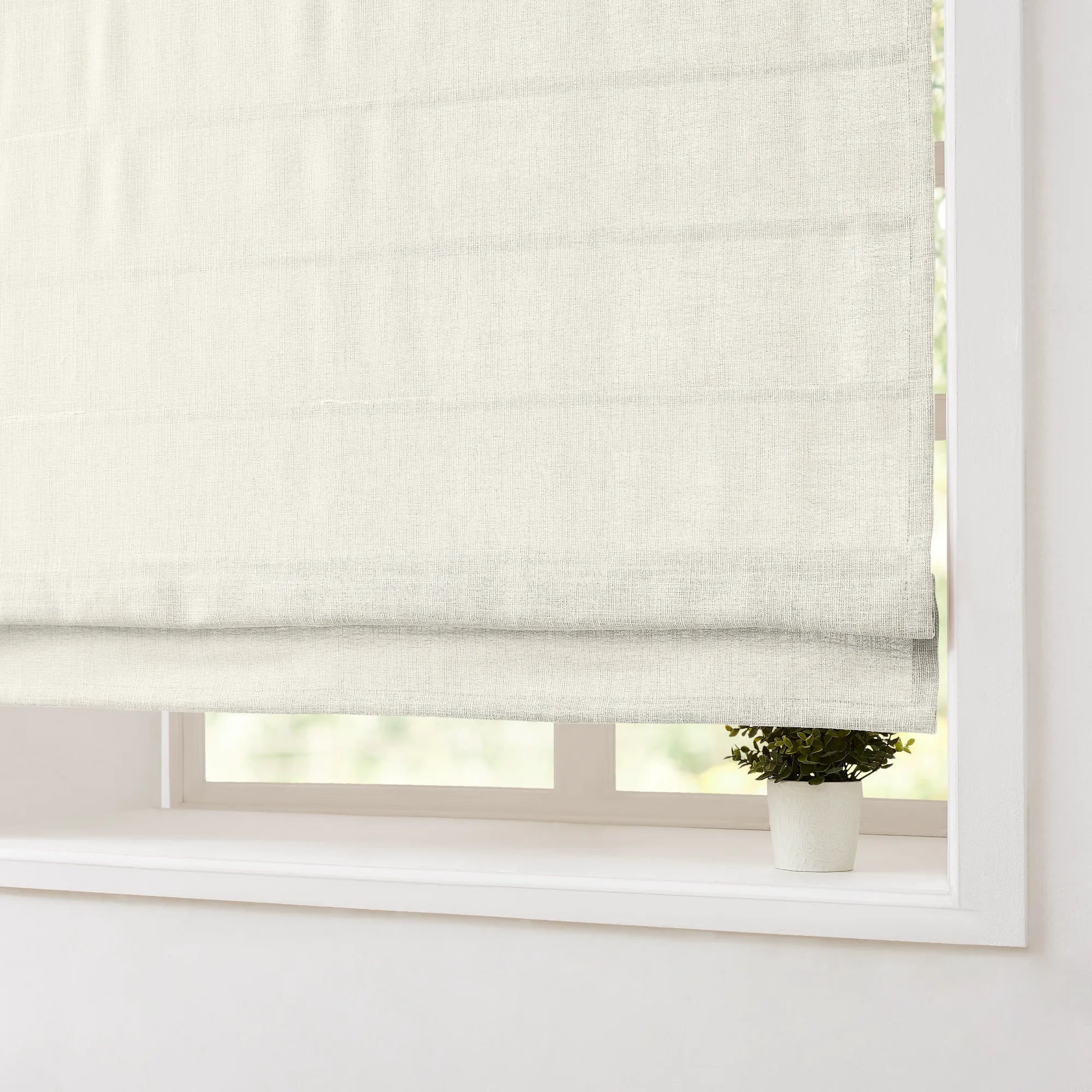 Fiora Cotton Motorized Roman Shades MBH9520-2 scene 2 - warm ivory cotton fabric, crisp tailored folds, quiet motor system, featured in sunlit contemporary living room with minimalist decor