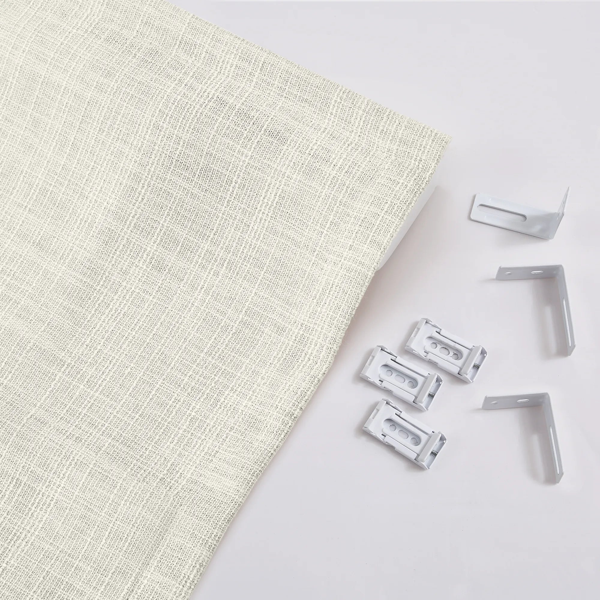 Fiora Cotton Motorized Roman Shades MBH9520-2 scene 5 - soft sand cotton fabric, smooth flat fold design, quiet motorized lift, displayed in a bright, modern home office with natural light and minimalist neutral furnishings