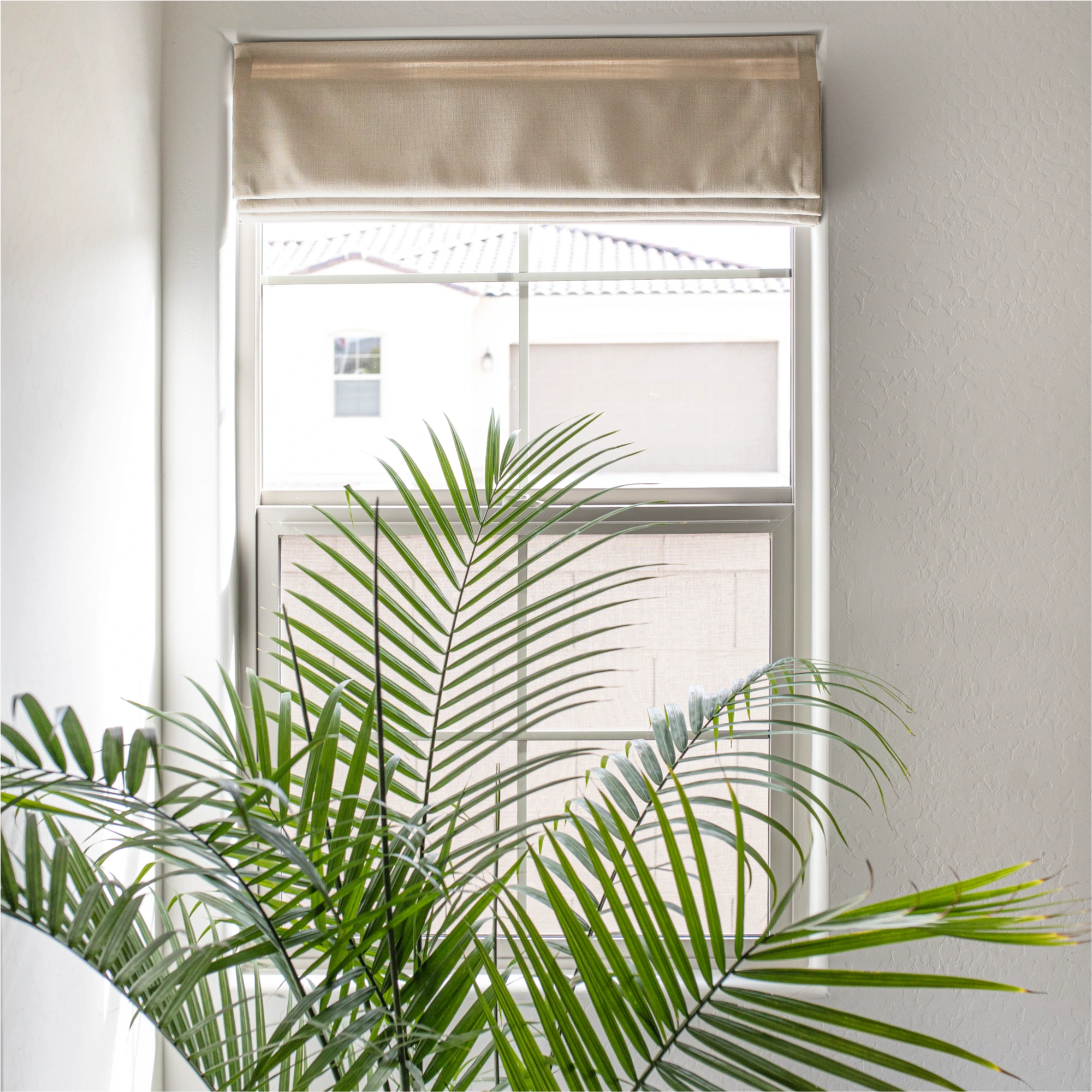 Ilythra cotton linen roman shades detail 4 showing a close-up view of the fabric on a window