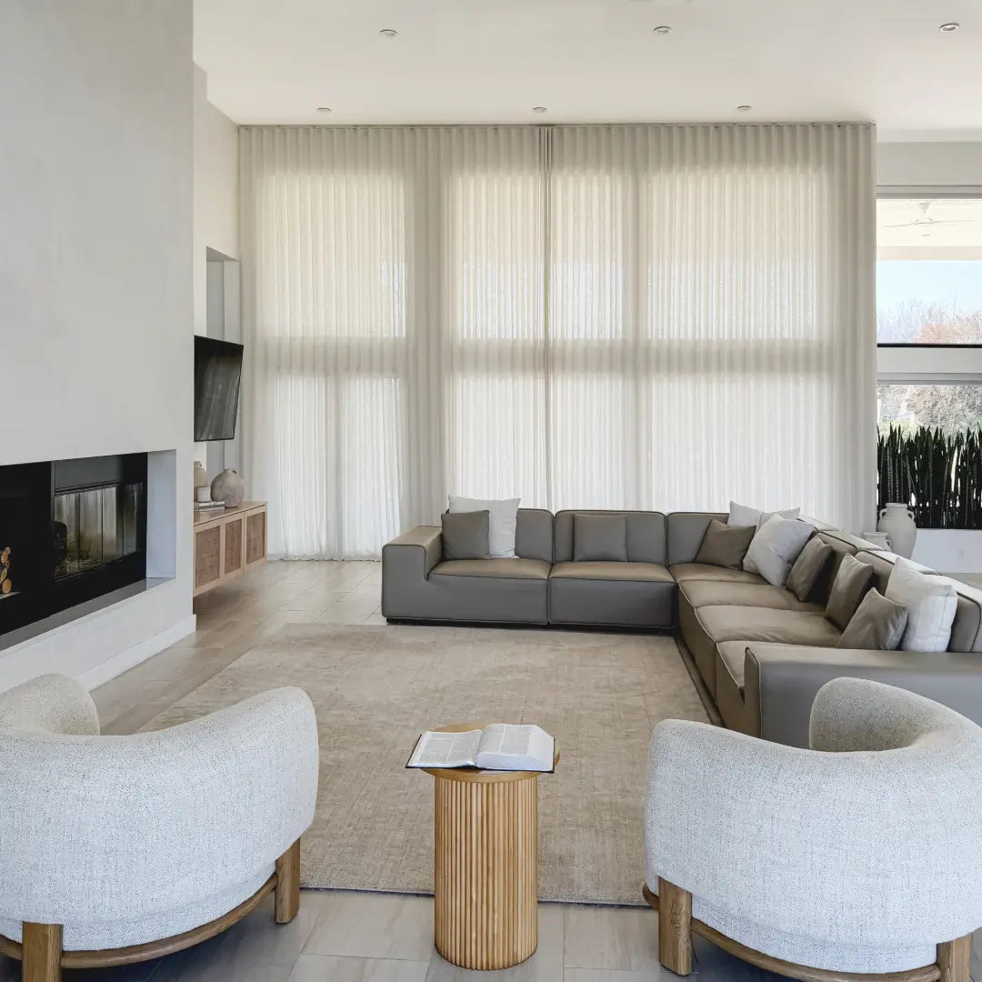 Translation missing: en.Modern living room with a sectional sofa, armchairs, and a fireplace