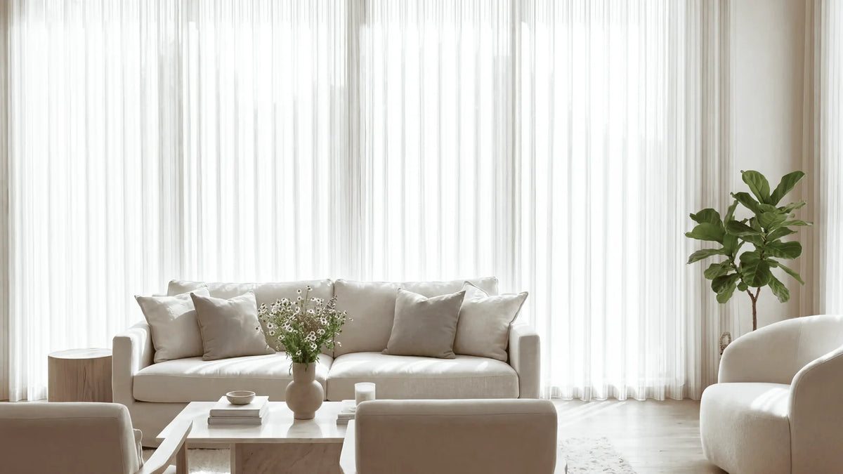 Wall-to-wall textured linen-blend sheer curtains hung from the ceiling in a bright modern living room