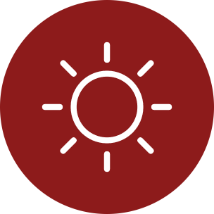 A circular red icon with a white sun symbol in the center, shown on a plain white background.