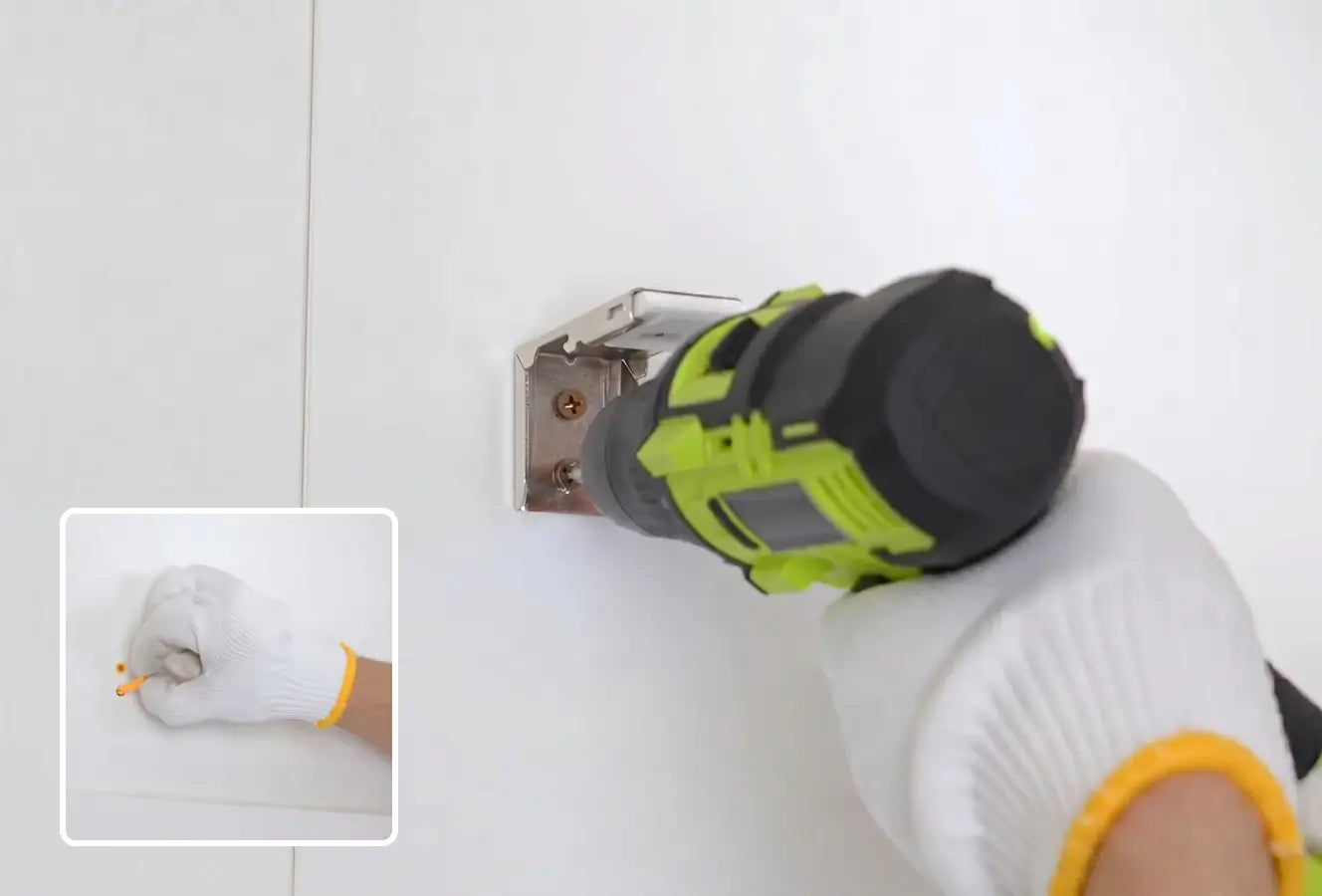 Person using a power tool on a white surface