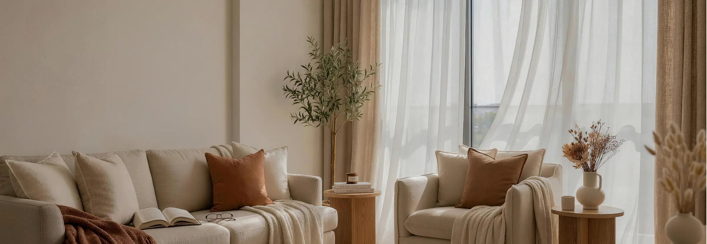 Modern living room with beige sofa, armchair, and decorative elements.