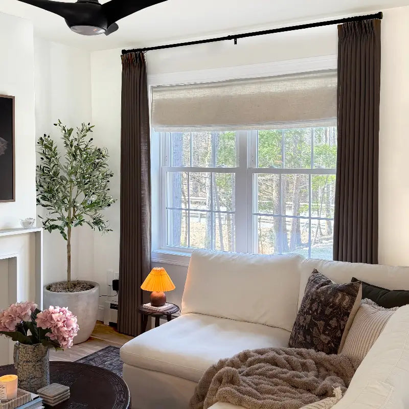 Layering custom curtains over blinds for a polished look