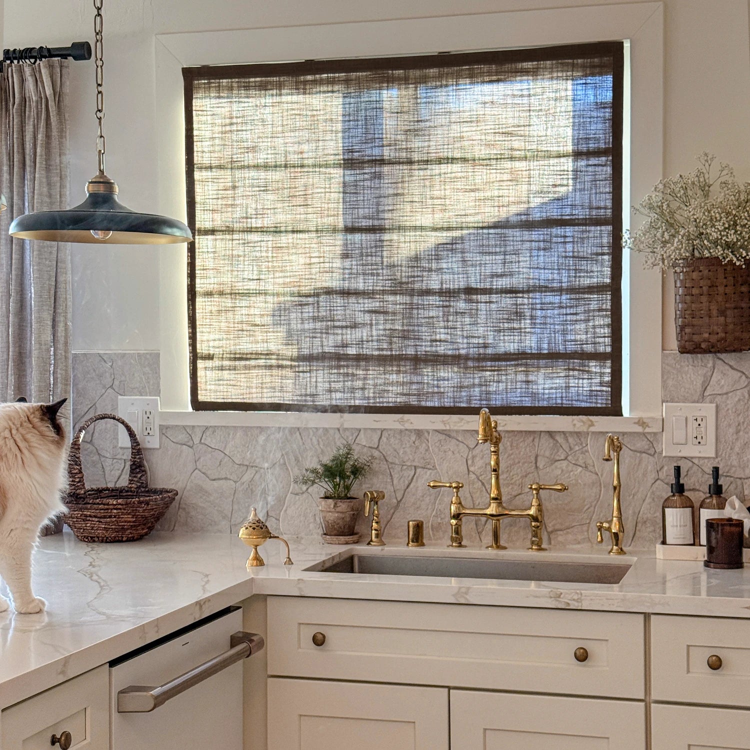 Elara 89850-10 elegant linen Roman shades closed over a kitchen sink view 3
