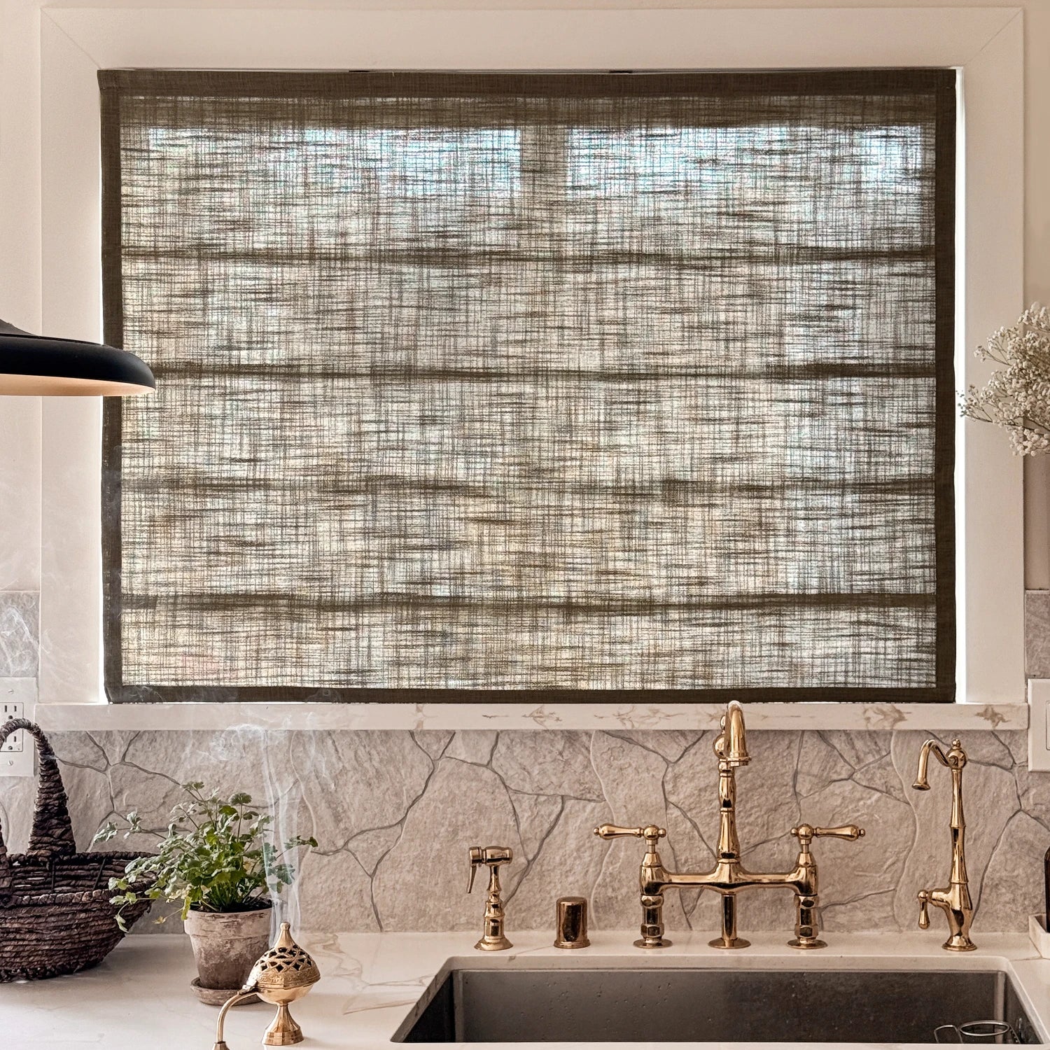 Elara 89850-10 elegant linen Roman shades closed over a kitchen sink