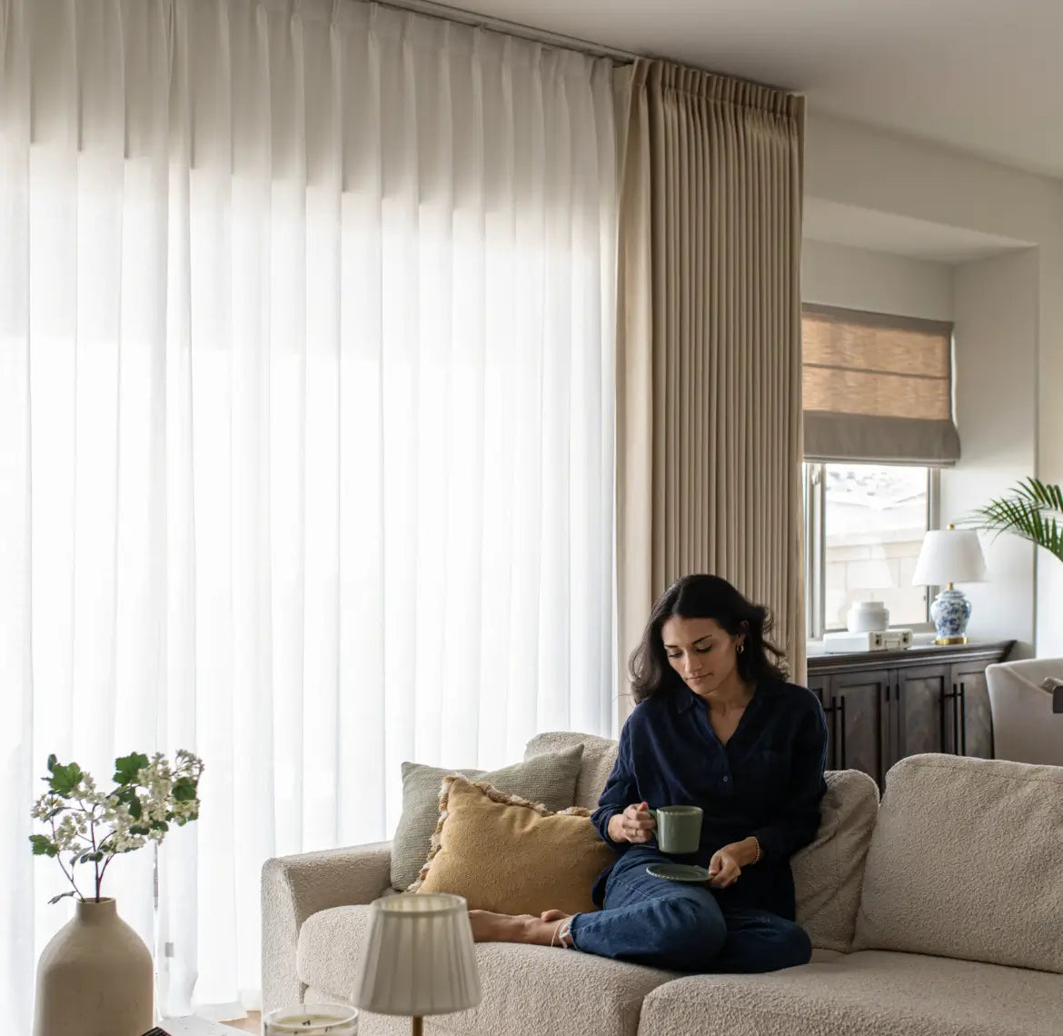 See through sheer curtains softly filtering light, creating a bright and airy ambiance.
